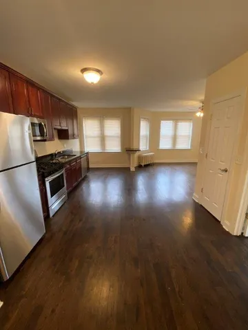 a view of a kitchen with a sink and a refrigerator