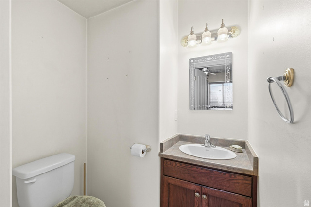 560 East 700 North Logan, UT 84321 - Photo 19 of 32 Vanity featuring a dark wood-finish cabinet with double doors, an undermount sink, and a countertop