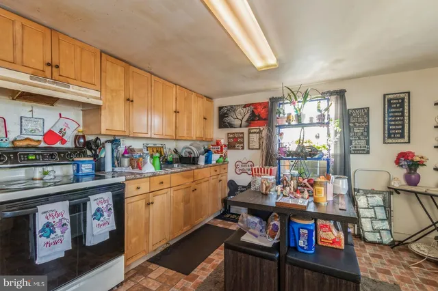 a kitchen with stainless steel appliances granite countertop a sink dishwasher and cabinets with wooden floor
