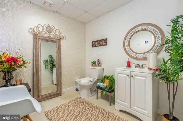 a bathroom with a toilet a mirror and a shower