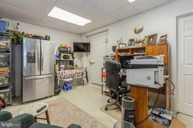 a living room with furniture gym equipment and a large window