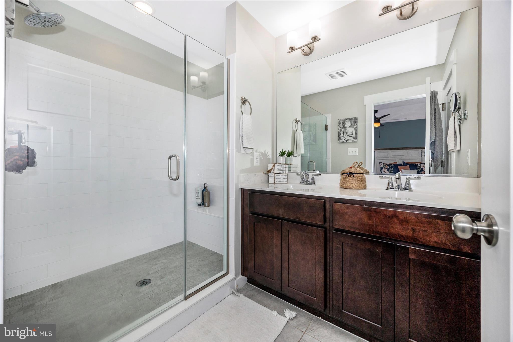 1314 Marsalis Place Frederick, MD 21702 - Photo 25 of 64 a bathroom with a double vanity sink mirror and shower