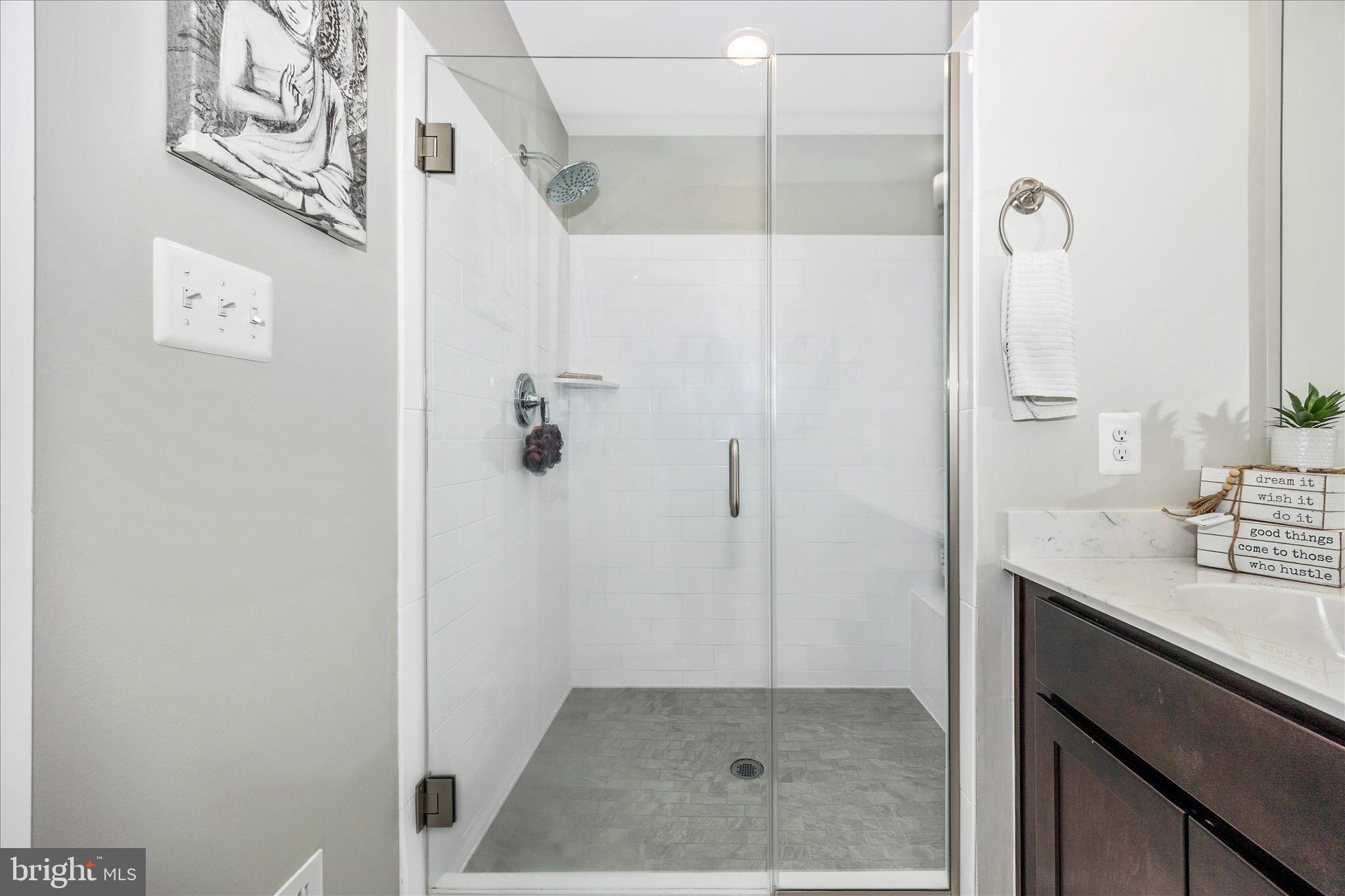 1314 Marsalis Place Frederick, MD 21702 - Photo 26 of 64 a bathroom with a granite countertop shower a sink and mirror