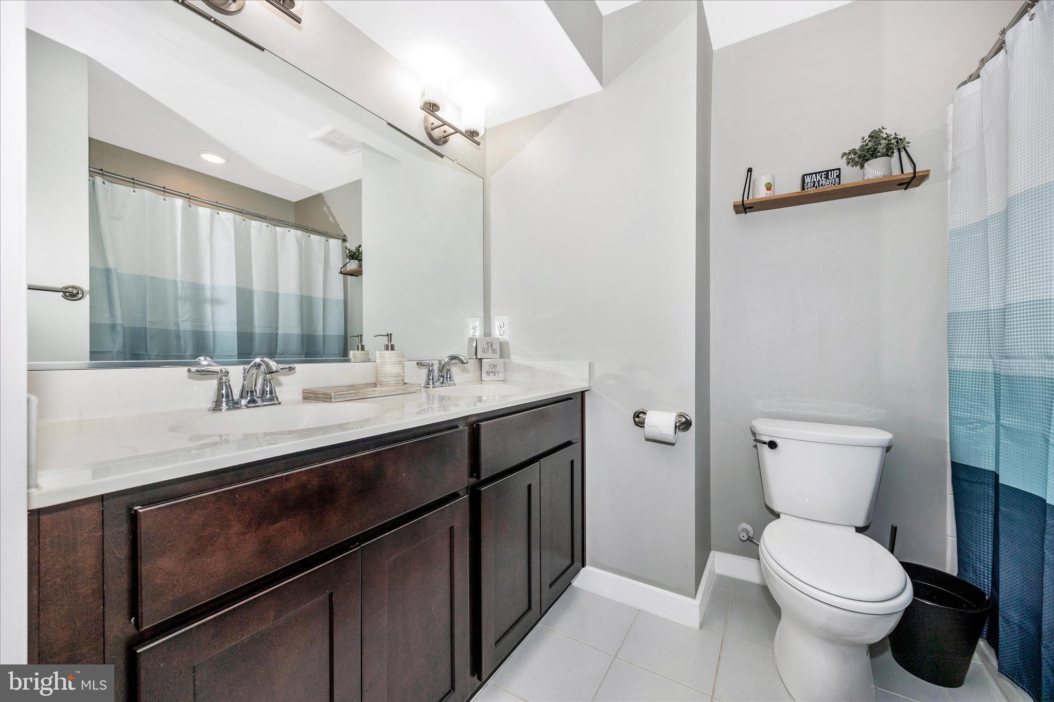1314 Marsalis Place Frederick, MD 21702 - Photo 31 of 64 a bathroom with a toilet sink and mirror