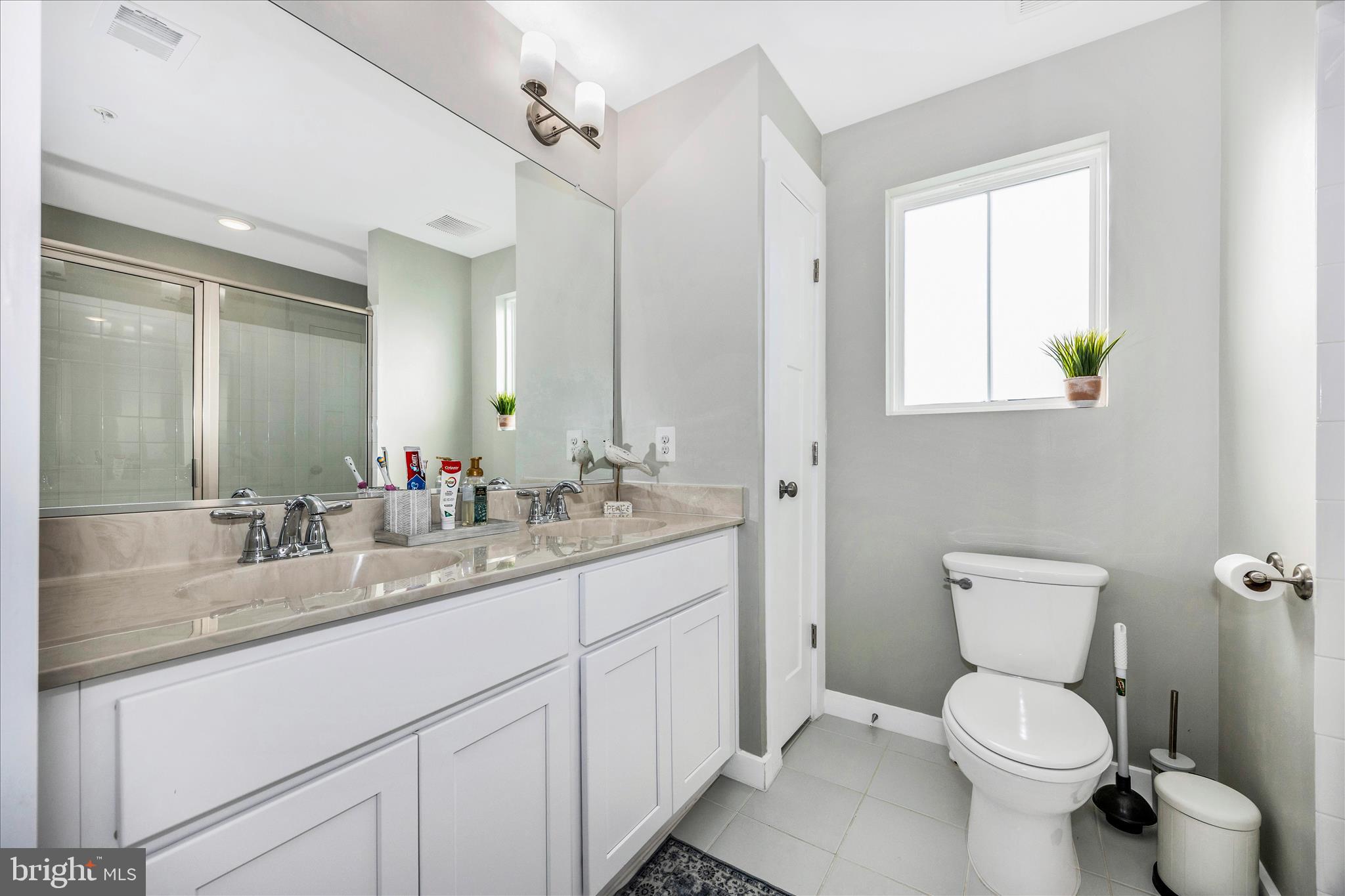 1314 Marsalis Place Frederick, MD 21702 - Photo 38 of 64 a bathroom with a granite countertop toilet sink and mirror