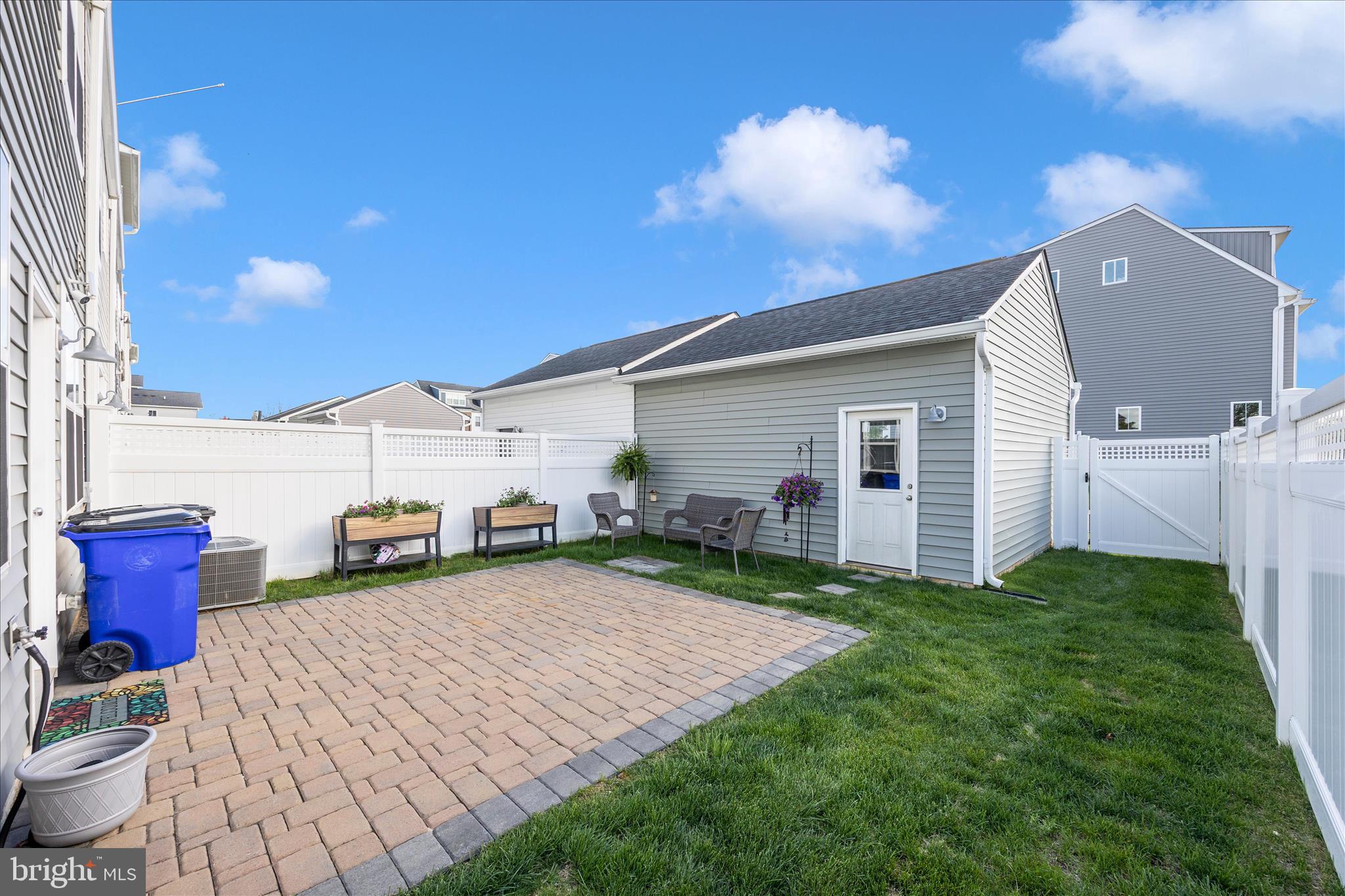 1314 Marsalis Place Frederick, MD 21702 - Photo 46 of 64 a view of a backyard with table and chairs with wooden fence