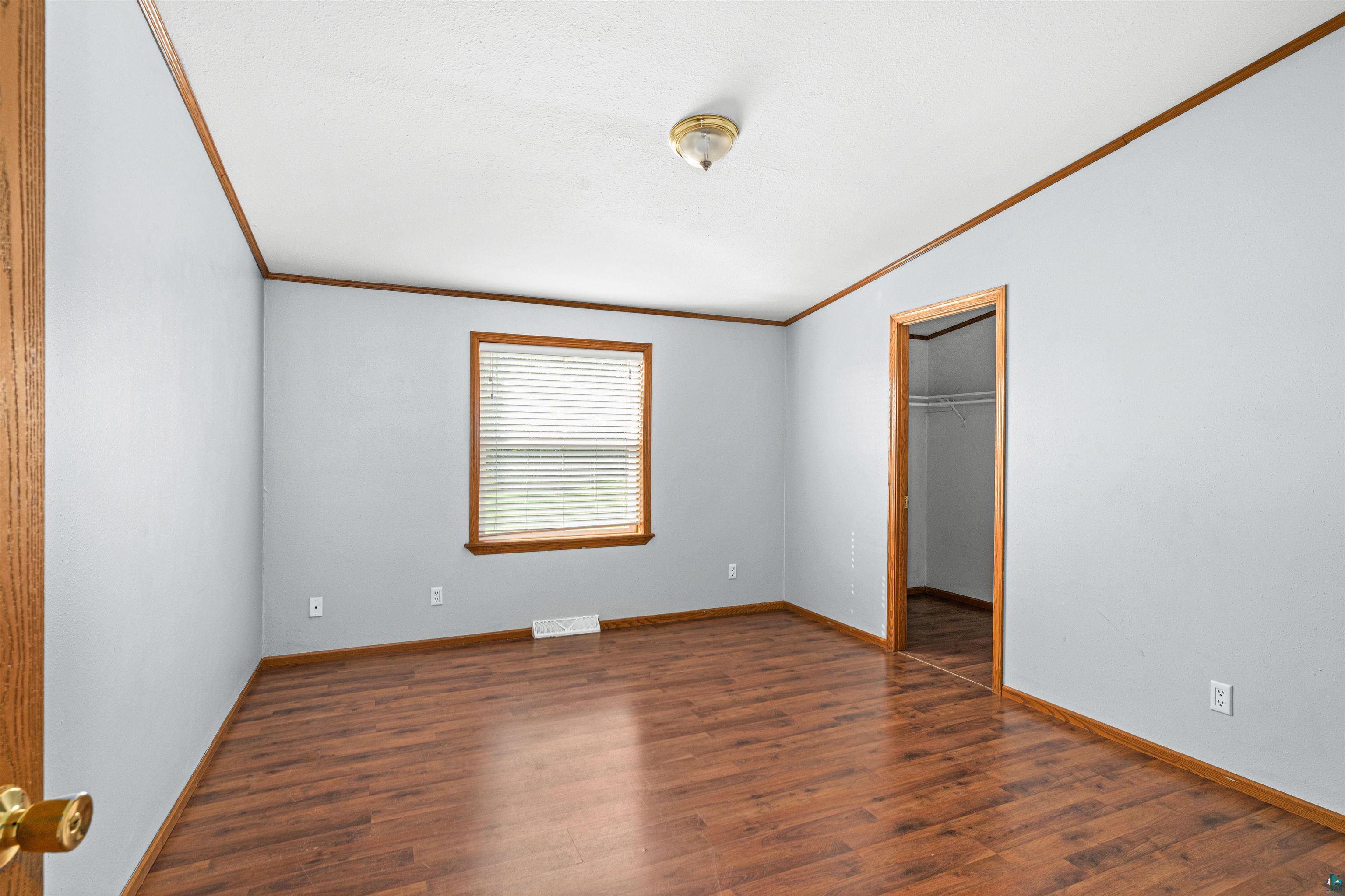 3126 Beyer Road Duluth, MN 55804 - Photo 20 of 23 Interior room featuring laminate flooring, light gray walls, and trim detailing