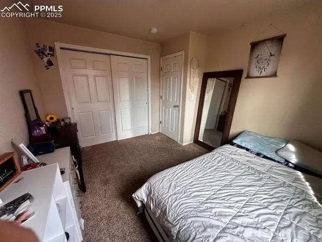 a bedroom with a bed and a dresser