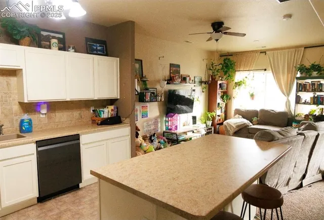 a kitchen that has a lot of cabinets a sink and a stove in it