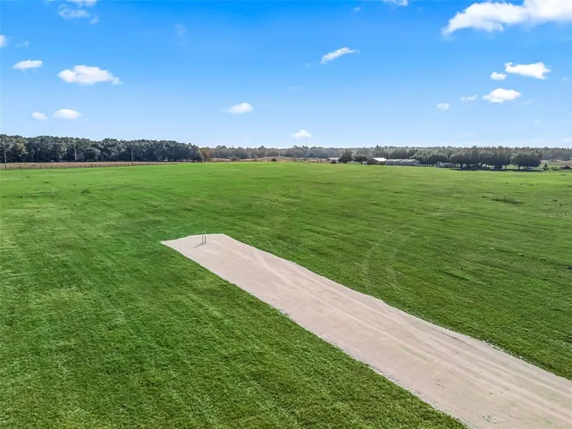 a view of a golf course with a big yard