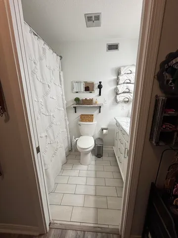 a bathroom with a toilet and a shower
