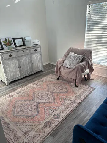 a spacious bedroom with a bed and wooden floor