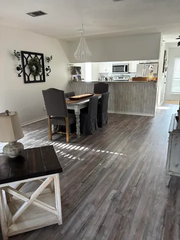 a view of a dining room with furniture and wooden floor