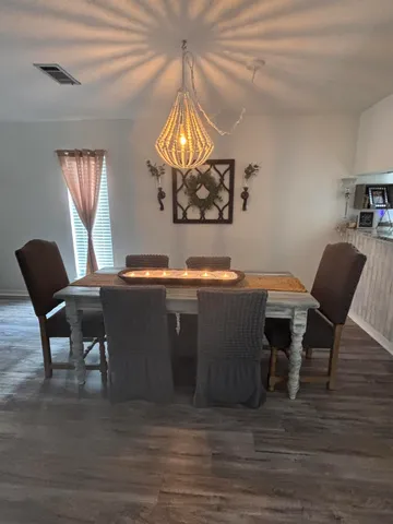 a view of a dining room with furniture and wooden floor