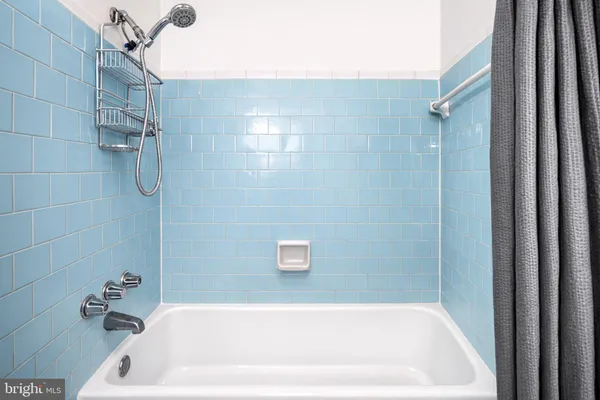 a bathroom with a bath tub and shower