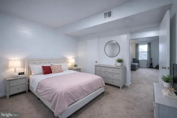 a bedroom with a bed and a dresser
