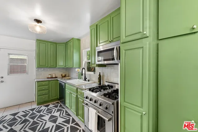 a kitchen with a sink stove and cabinets