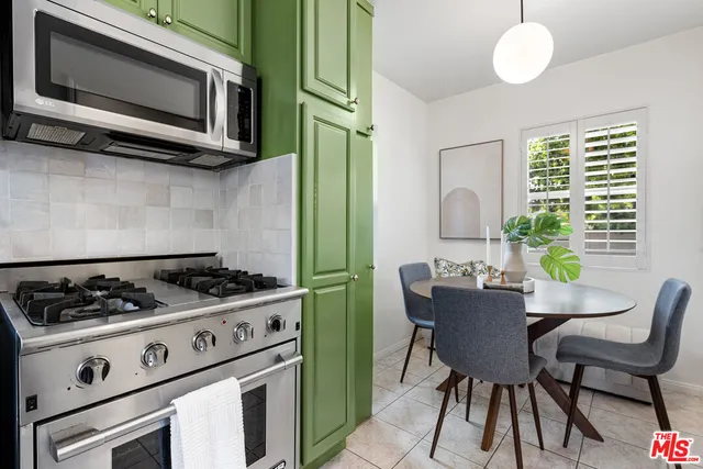 a kitchen with a stove a microwave and wooden floor
