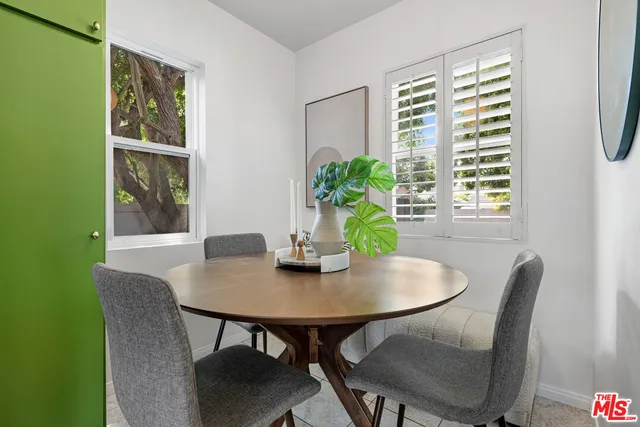 a view of a dining room with furniture and a window