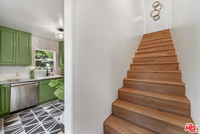 a bedroom with bed and a potted plant