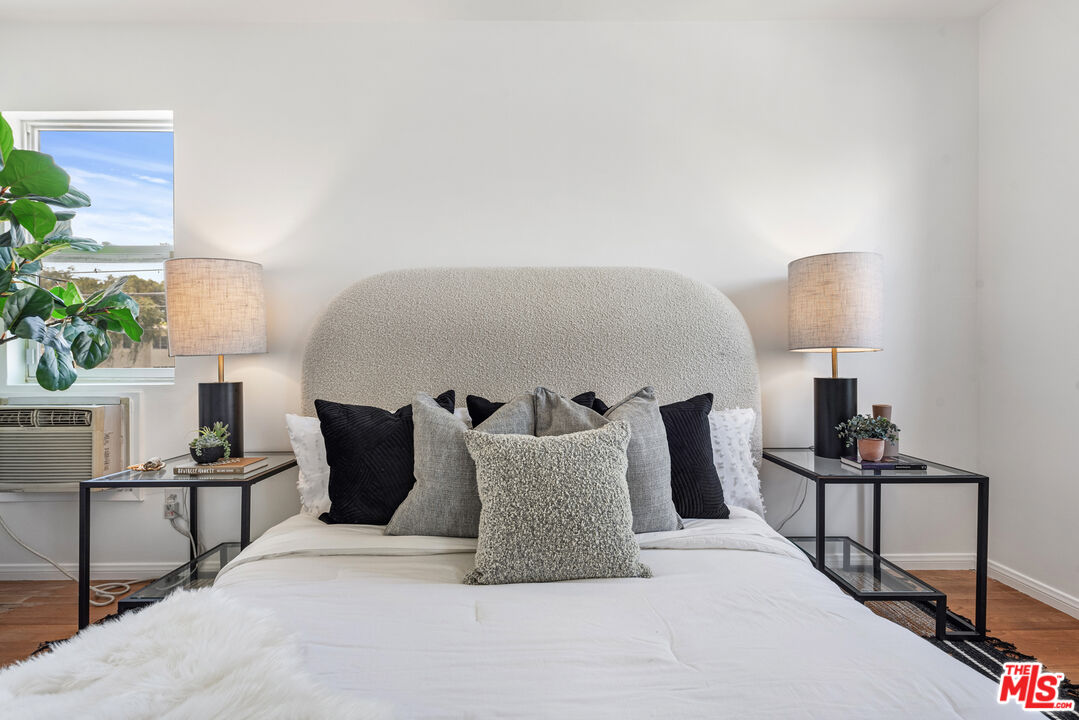 1205 Appleton Way Venice, CA 90291 - Photo 28 of 52 a large bed sitting in a bedroom next to a lamp with a potted plant on a table