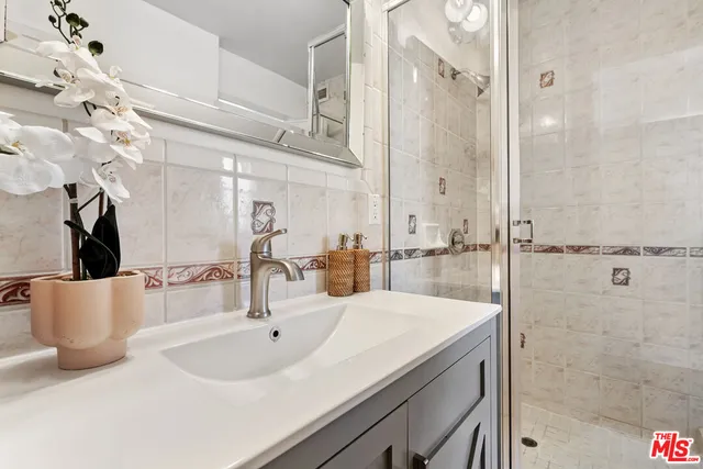 a bathroom with a bathtub sink mirror vanity and toilet