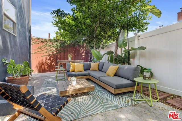 a view of a backyard with furniture and a fire pit