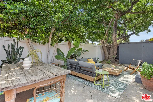 a outdoor living room with furniture and a potted plant