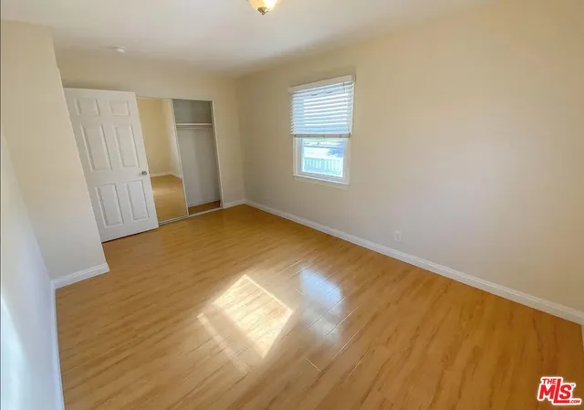 a view of walk in closet with wooden floor and floors