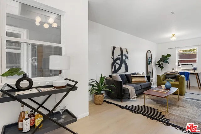 a view of a livingroom with furniture and floor to ceiling window