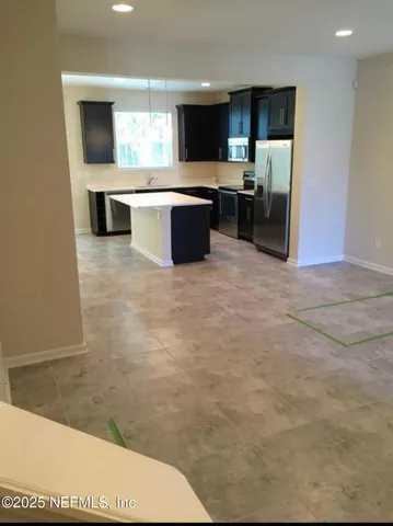 a view of kitchen with sink microwave and stove