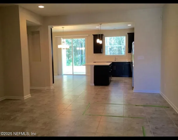 a view of kitchen with granite countertop window and front door
