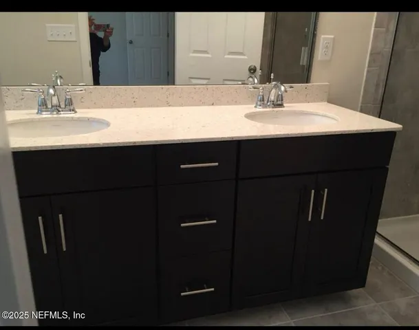 a bathroom with a sink and a mirror