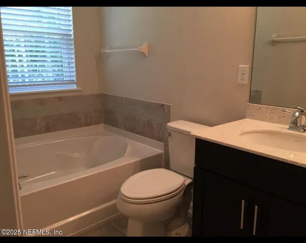 a bathroom with a sink a toilet and bathtub