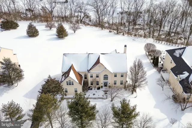 a view of a white house with a snow on the road