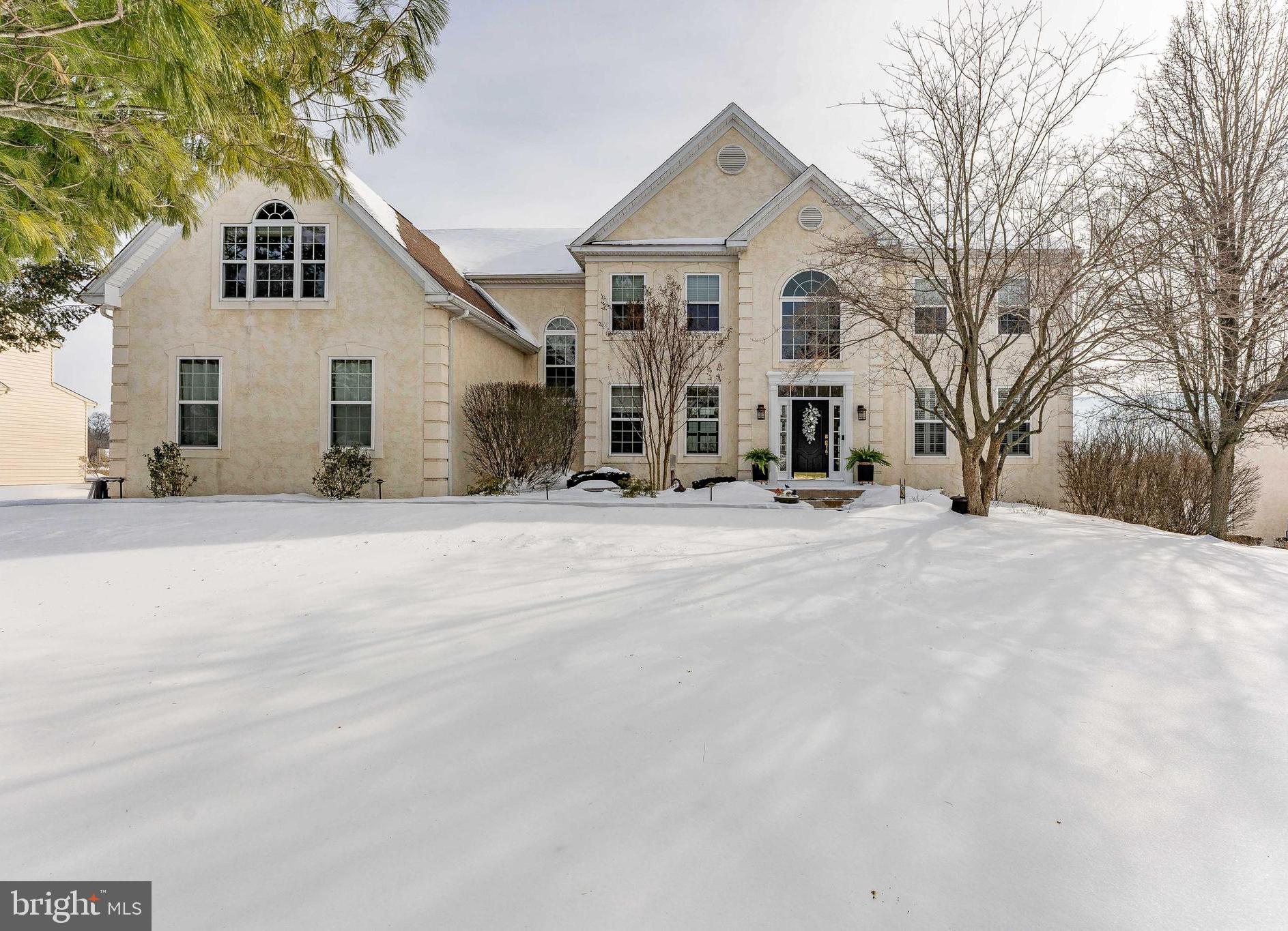 a view of a white house with a snow on the road