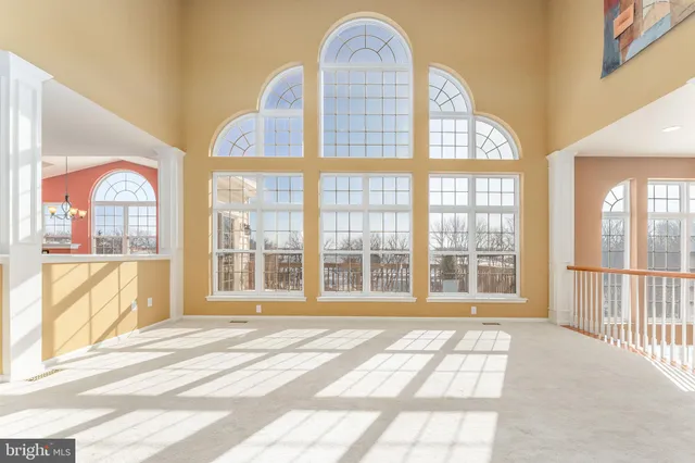 a view of staircase with lots of windows and white walls