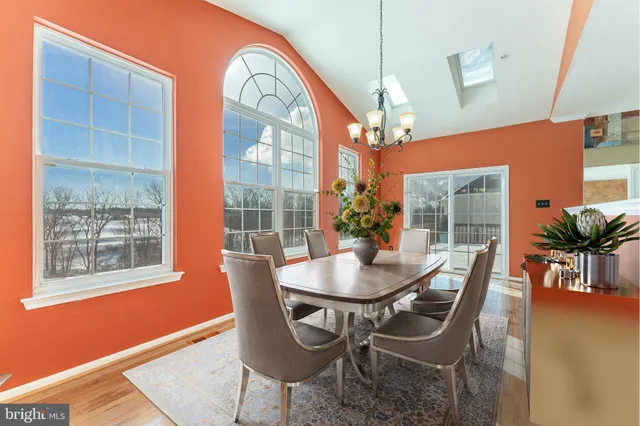 a living room with furniture a table and a large window