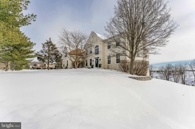 a living room with furniture a wooden floor and a large window