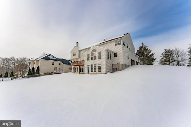 a large kitchen with stainless steel appliances kitchen island granite countertop a sink a counter space and a window