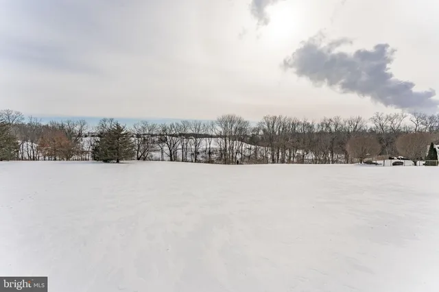 a kitchen with stainless steel appliances granite countertop a kitchen island hardwood floor sink stove dining table and chairs
