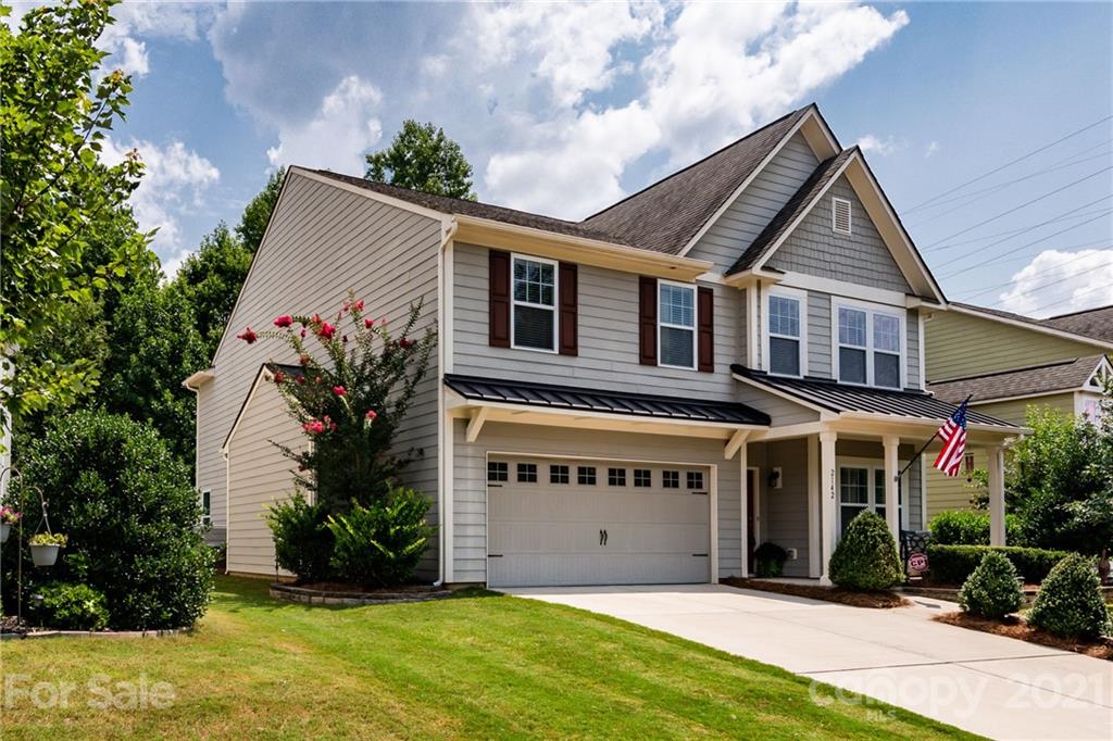 2142 Bluebell Way Tega Cay, SC 29708 - Photo 2 of 48 a front view of a house with a yard and garage