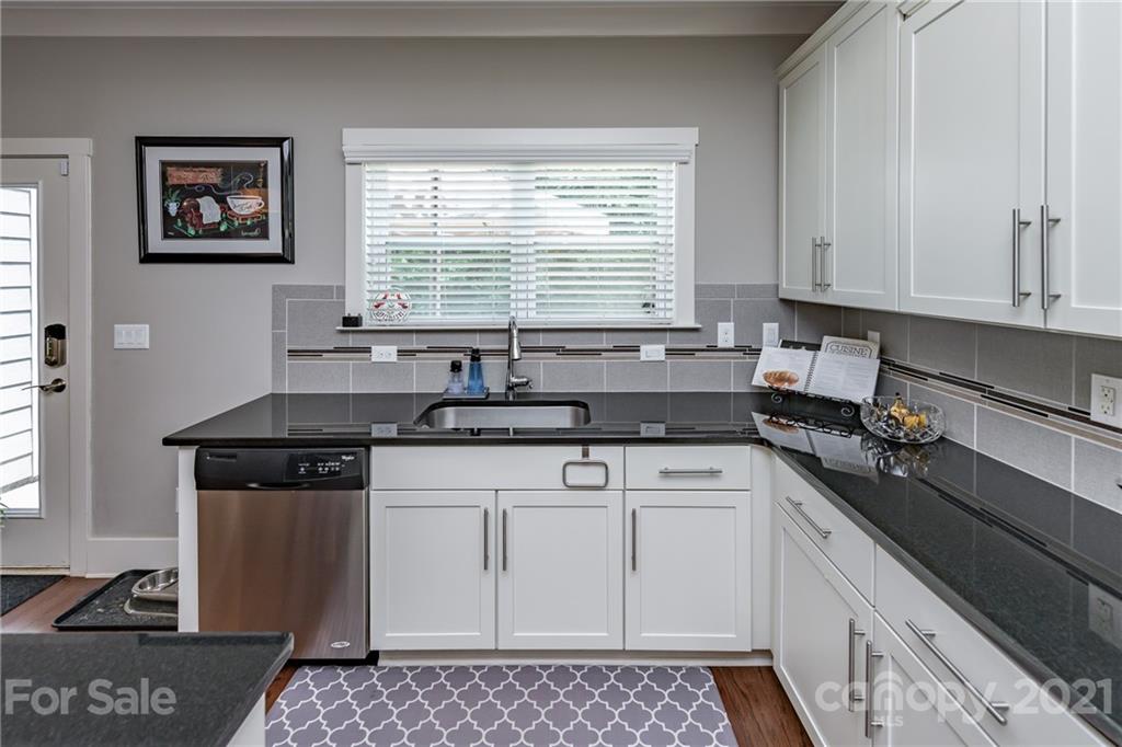 2142 Bluebell Way Tega Cay, SC 29708 - Photo 11 of 48 a kitchen with stainless steel appliances granite countertop a sink stove and cabinets