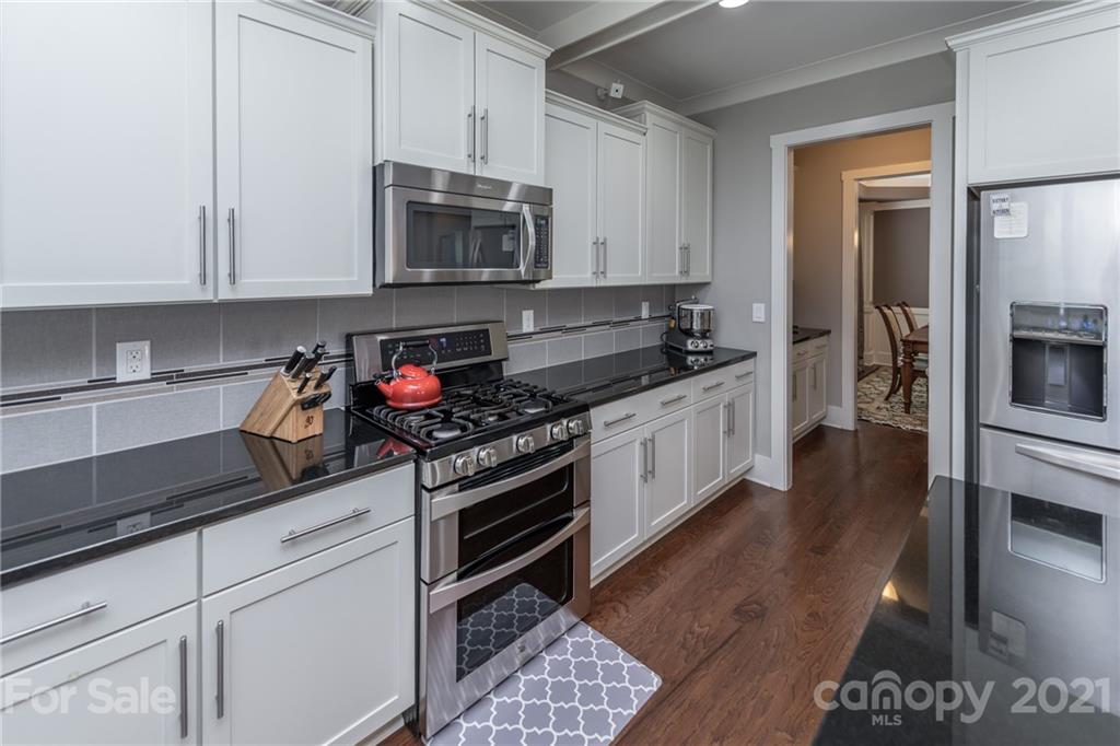 2142 Bluebell Way Tega Cay, SC 29708 - Photo 12 of 48 a kitchen with stainless steel appliances granite countertop a stove a sink and a microwave