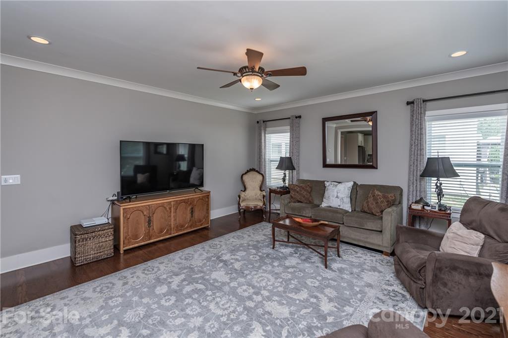 2142 Bluebell Way Tega Cay, SC 29708 - Photo 16 of 48 a living room with furniture a flat screen tv and a window