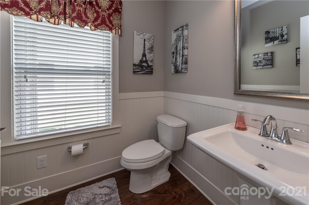 2142 Bluebell Way Tega Cay, SC 29708 - Photo 19 of 48 a bathroom with a toilet sink and mirror