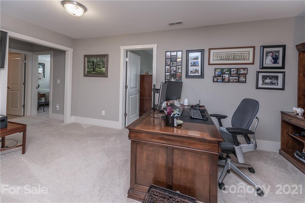 2142 Bluebell Way Tega Cay, SC 29708 - Photo 22 of 48 a view of a workspace with furniture and a window