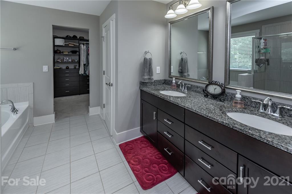 2142 Bluebell Way Tega Cay, SC 29708 - Photo 25 of 48 a bathroom with a granite countertop sink a toilet and shower