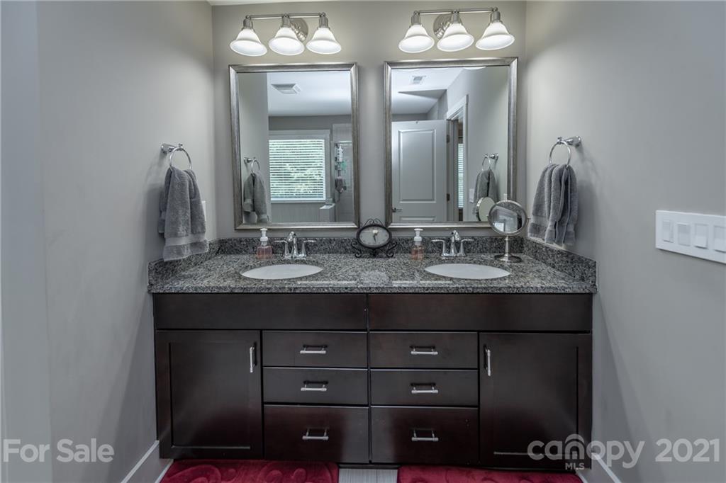 2142 Bluebell Way Tega Cay, SC 29708 - Photo 26 of 48 a bathroom with a double vanity and a mirror