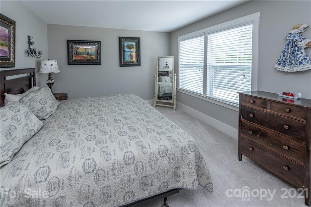 2142 Bluebell Way Tega Cay, SC 29708 - Photo 31 of 48 a bedroom with a bed and a window
